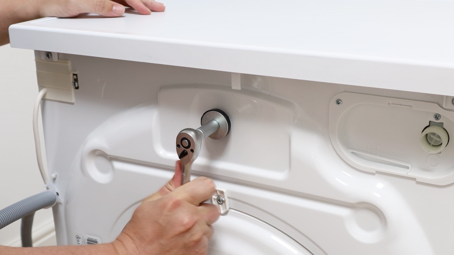 Remove transit bolt with 10mm socket