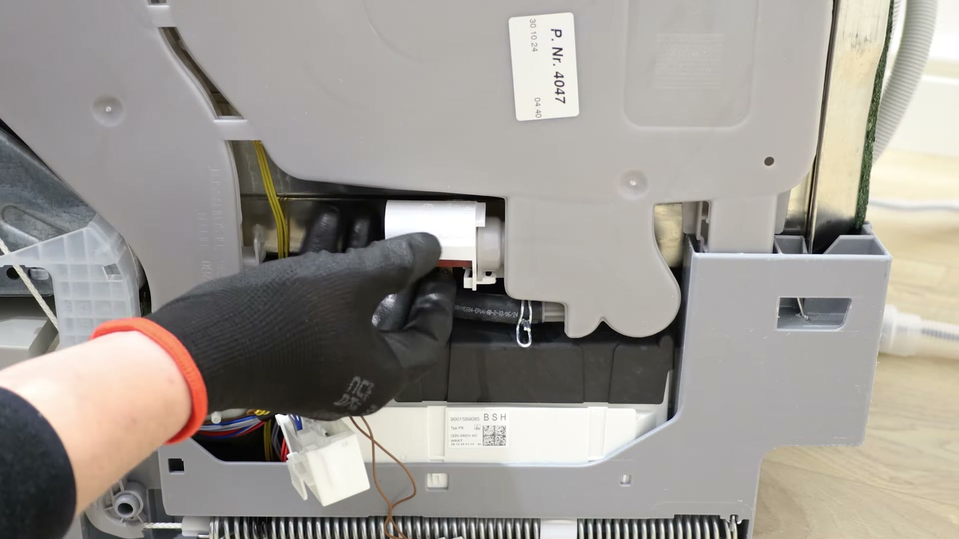 Fitting the new actuator into the side chamber of a Bosch dishwasher