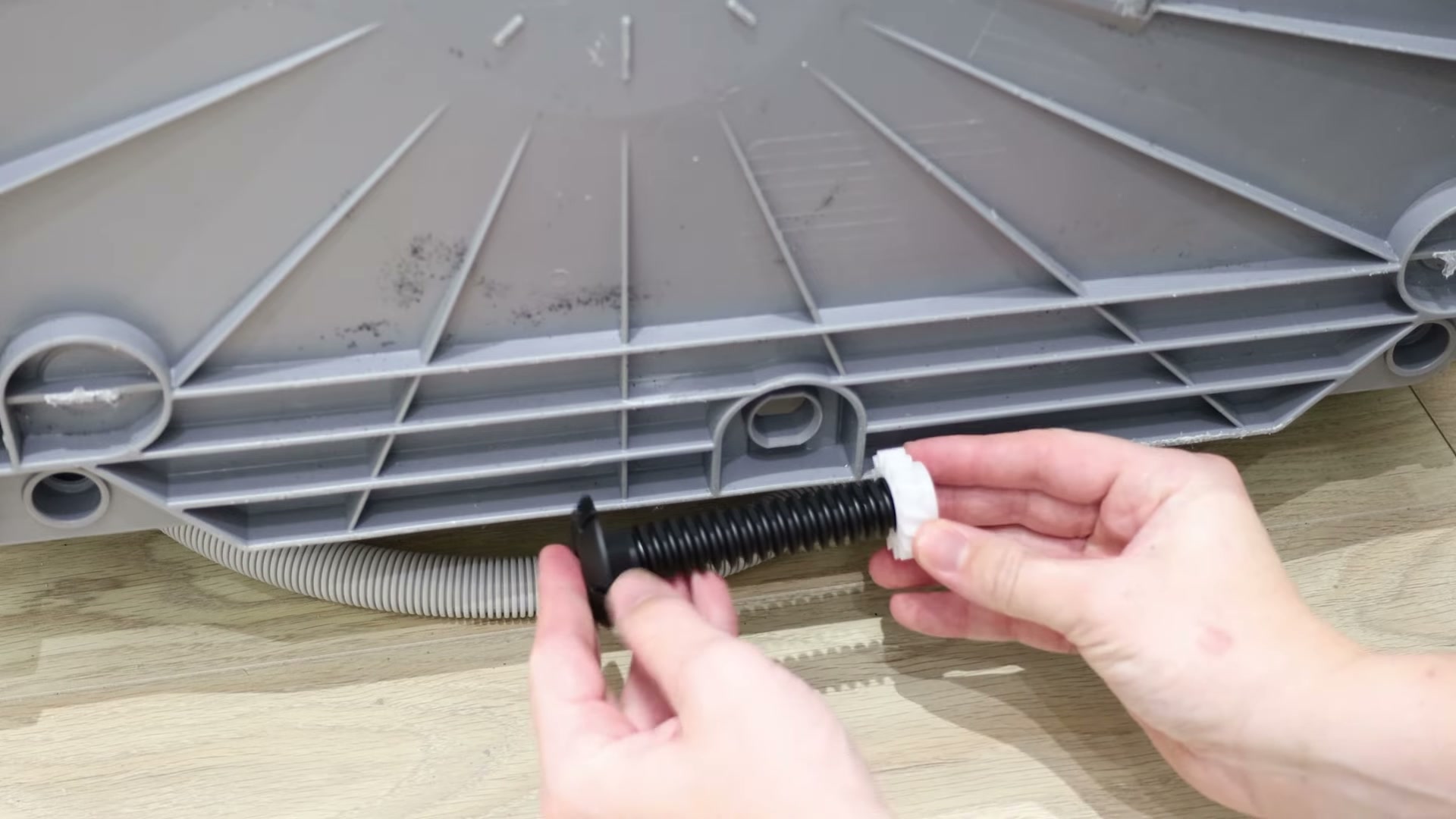 Showing how the new adjustable foot connects to the plastic gear wheel on a Bosch dishwasher