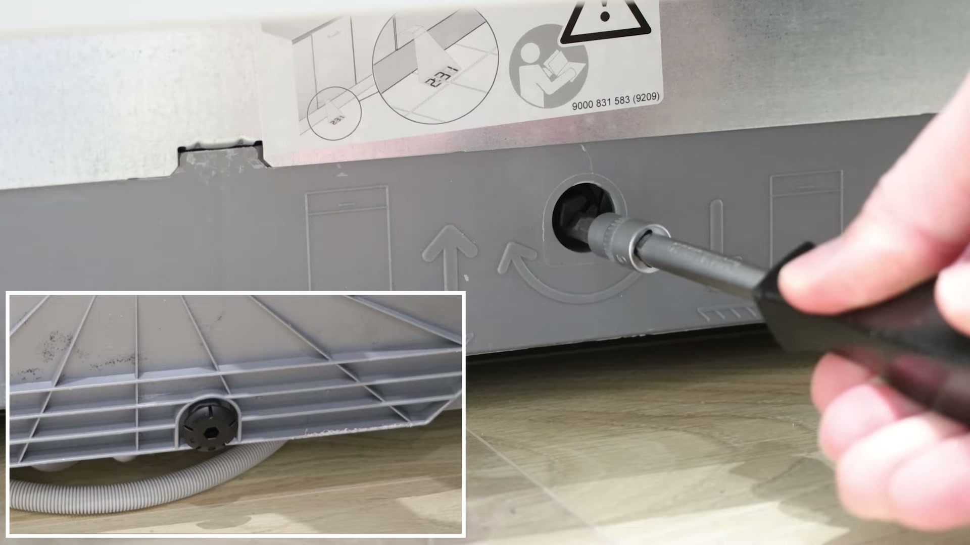 Adjusting the rear foot of a Bosch dishwasher with a wrench to level the machine