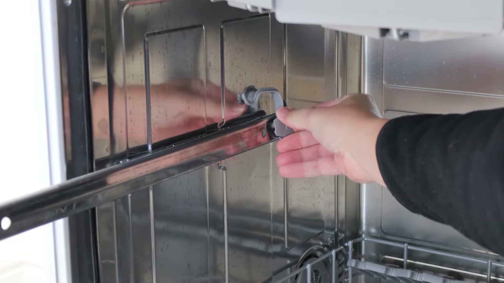 New basket rail clip being clicked onto the end of a Bosch dishwasher side rail