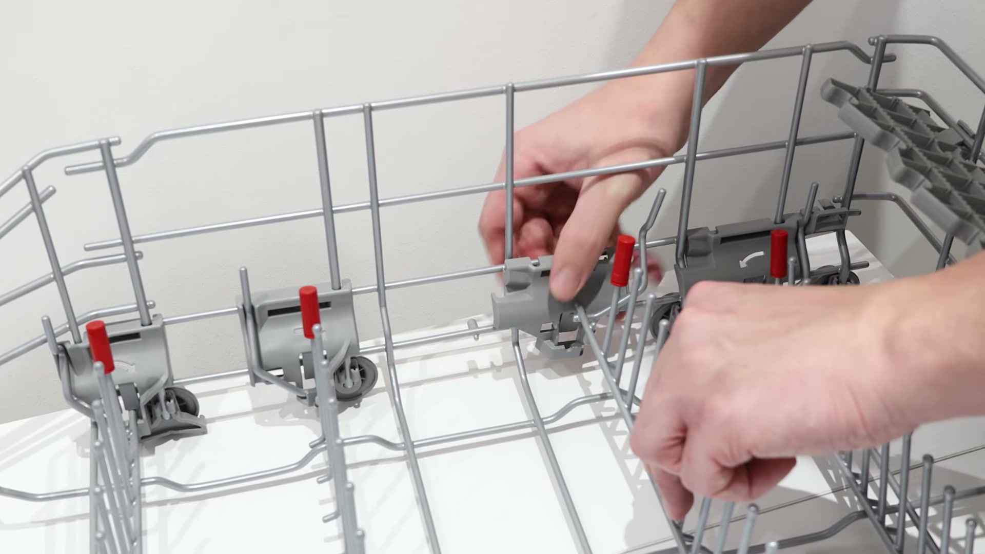 Fitting a new Bosch dishwasher bearing onto the plate holder with the arrow pointing down