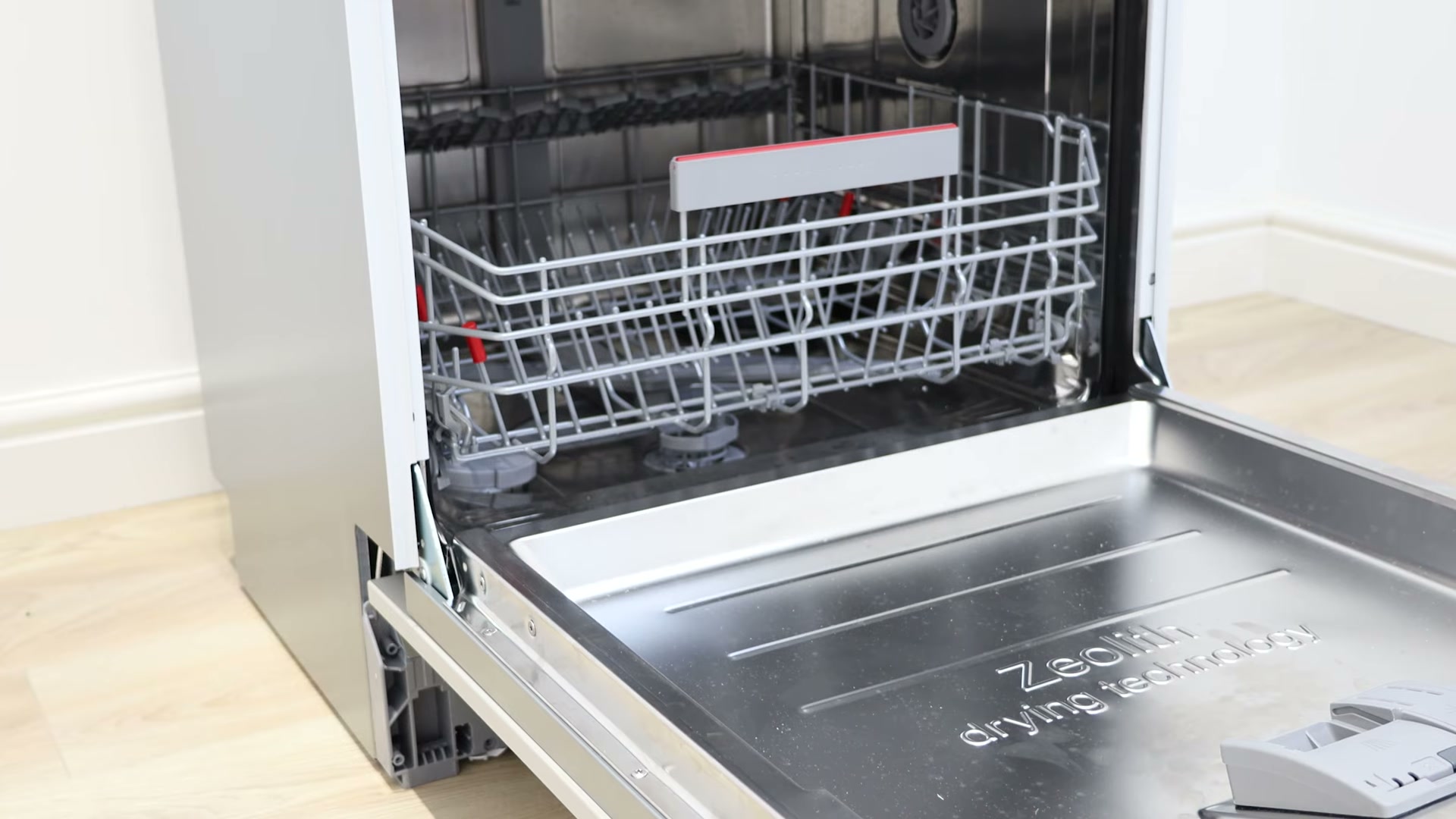 The Bosch dishwasher bottom basket reinserted into the dishwasher after fitting the new bearing