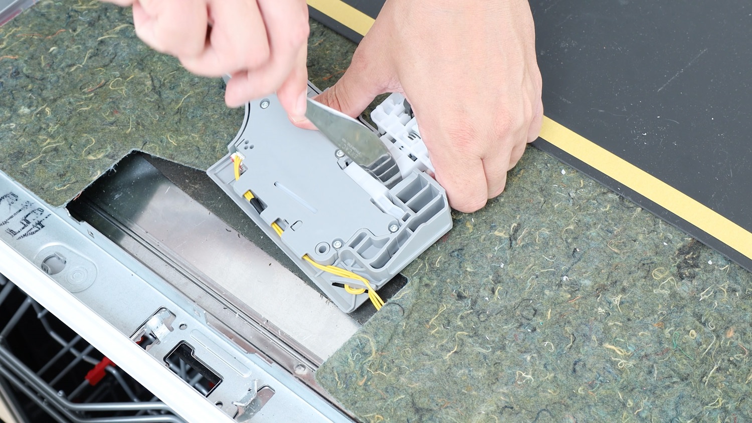 with blunt knife, remove door latch interlock from module