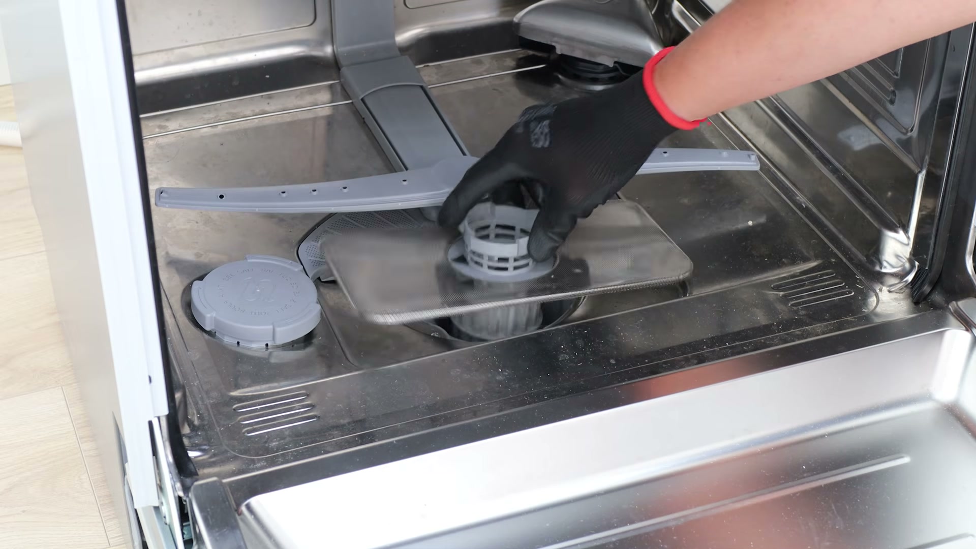 Lifting the filter and drain filter plate out of the dishwasher base