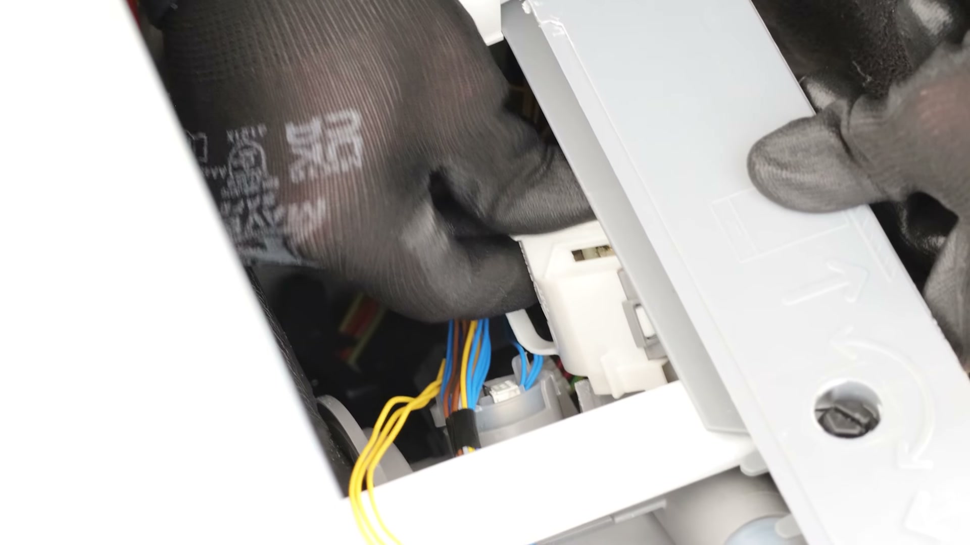 New drain pump being rotated anticlockwise into the sump housing of a Bosch dishwasher