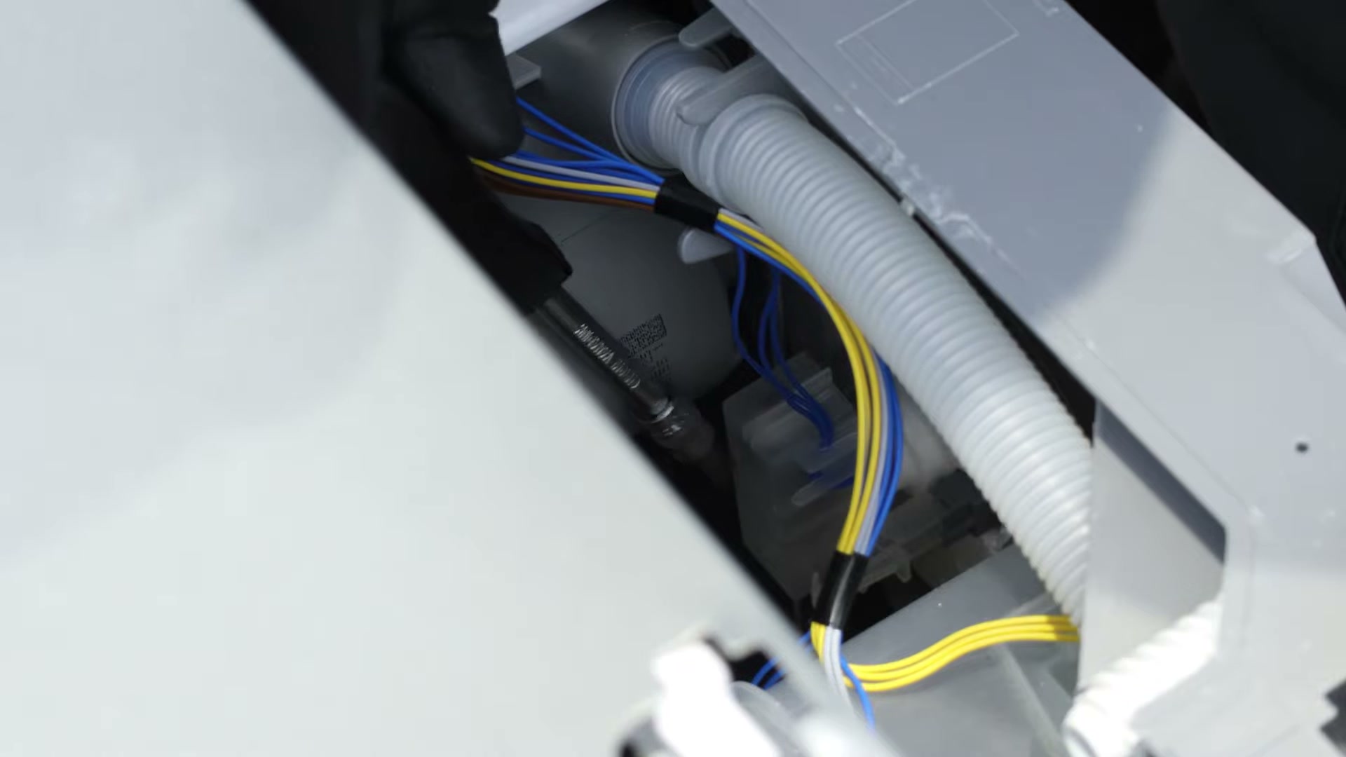 New float switch casing clipped into the mounting bracket on a Bosch dishwasher base tray