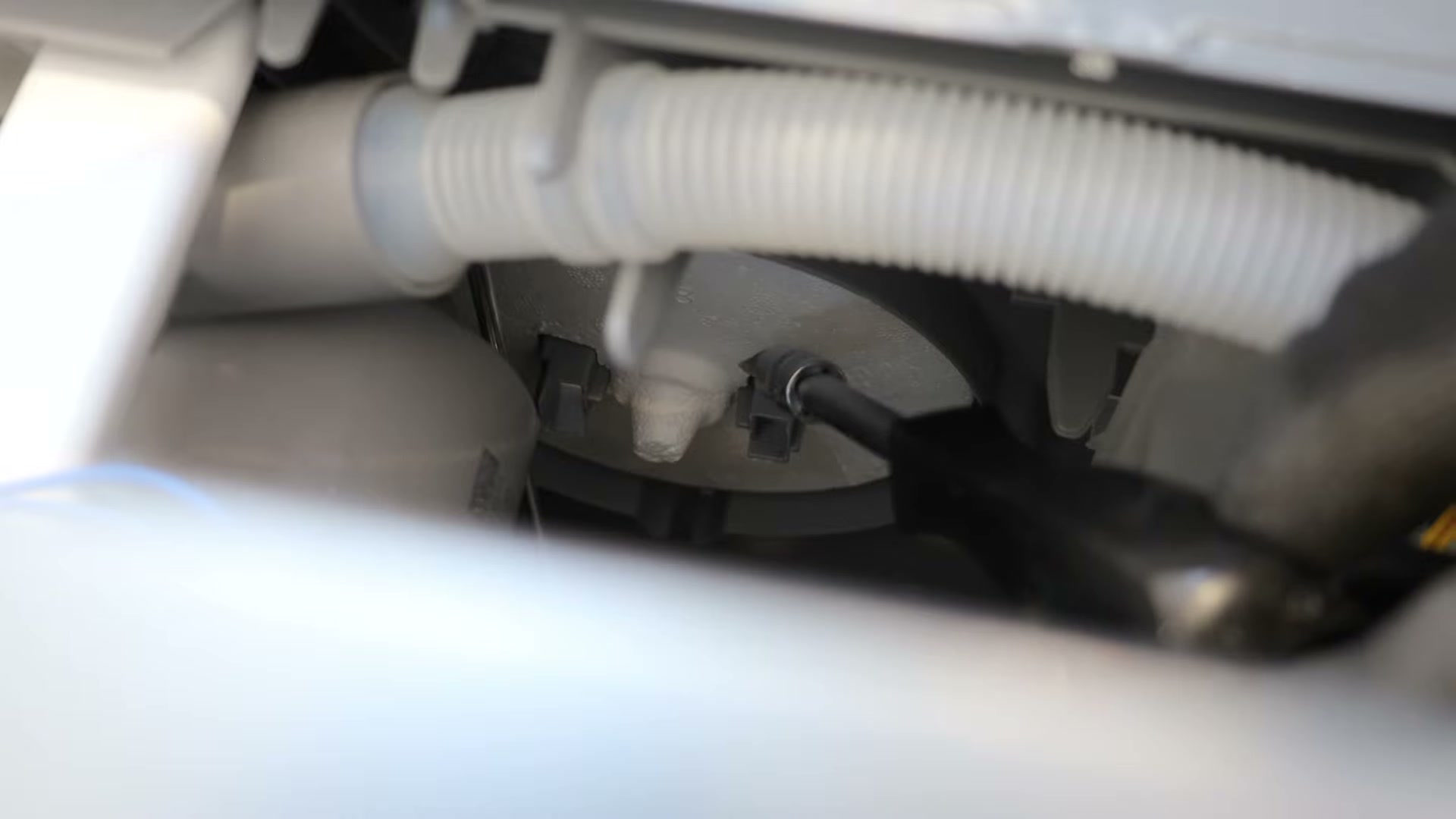 Location of the float switch and white polystyrene float on a Bosch dishwasher base tray