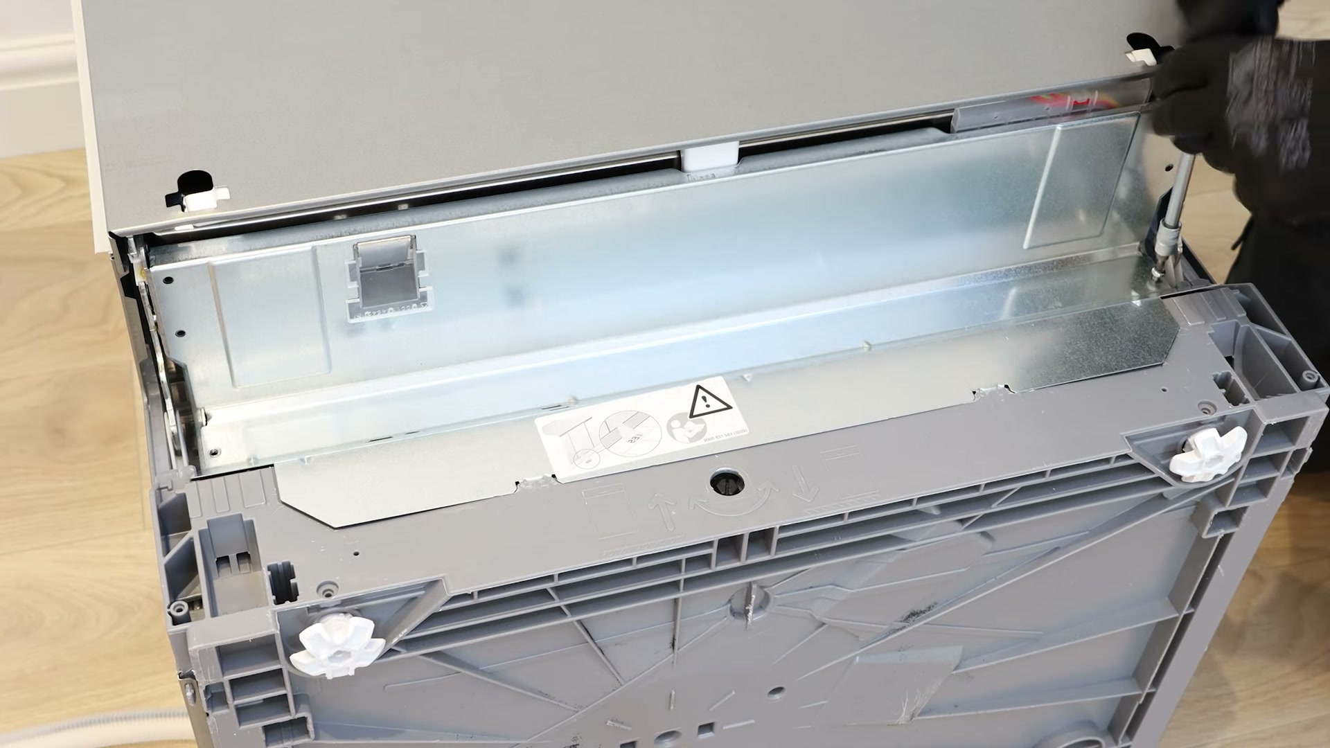 Removing the two screws holding the access panel