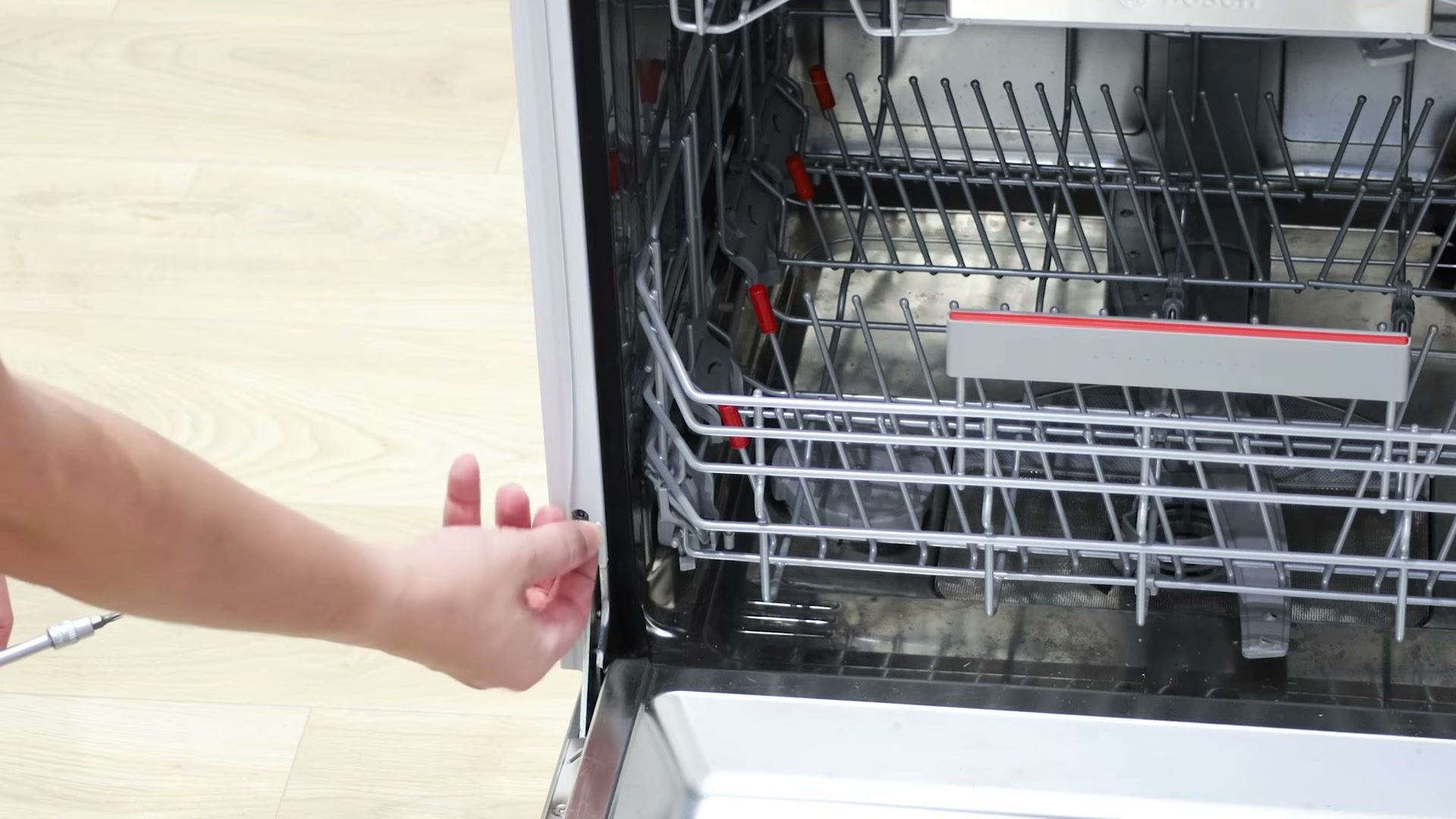 Removing the side panel from a Bosch dishwasher to access the regeneration valve