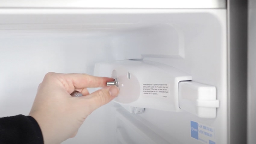 Remove temperature dial nut and screw from fridge freezer