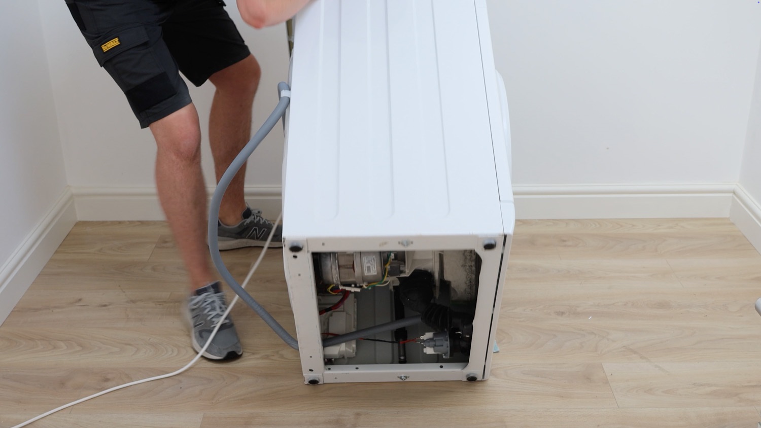 Lay machine on ground to access the bottom