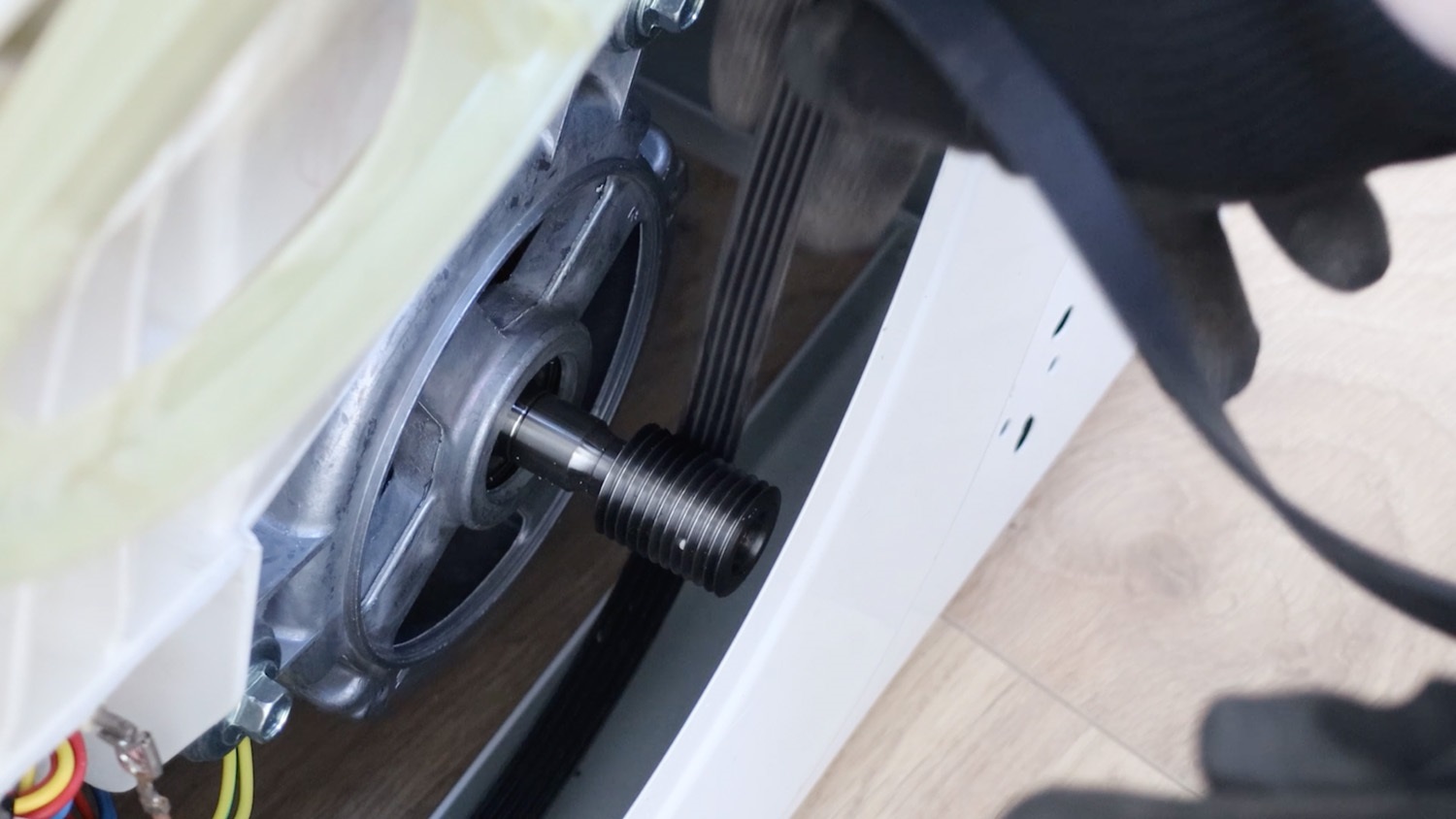 Attach belt to motor spindle