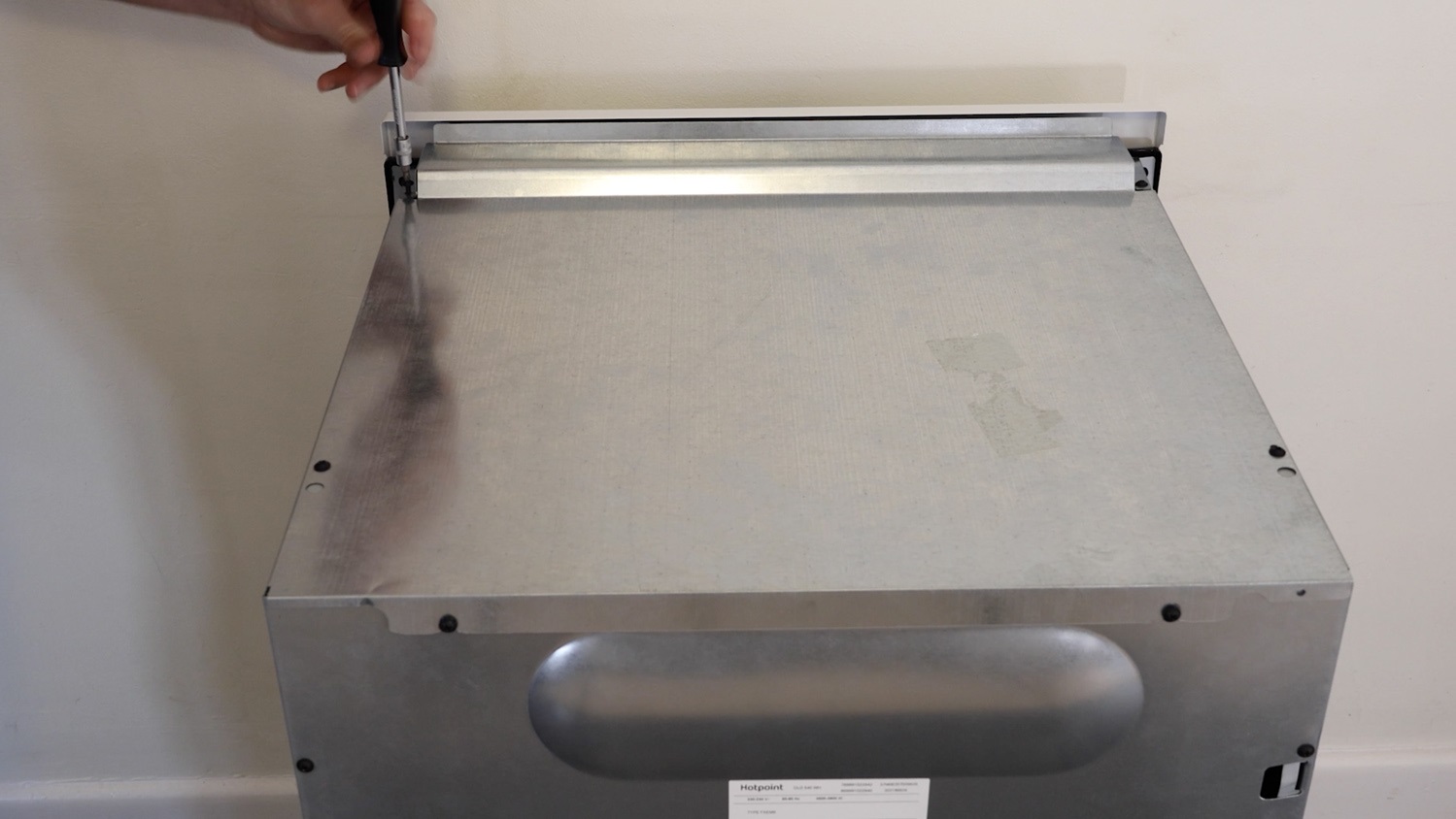 Re-screw screws on top panel