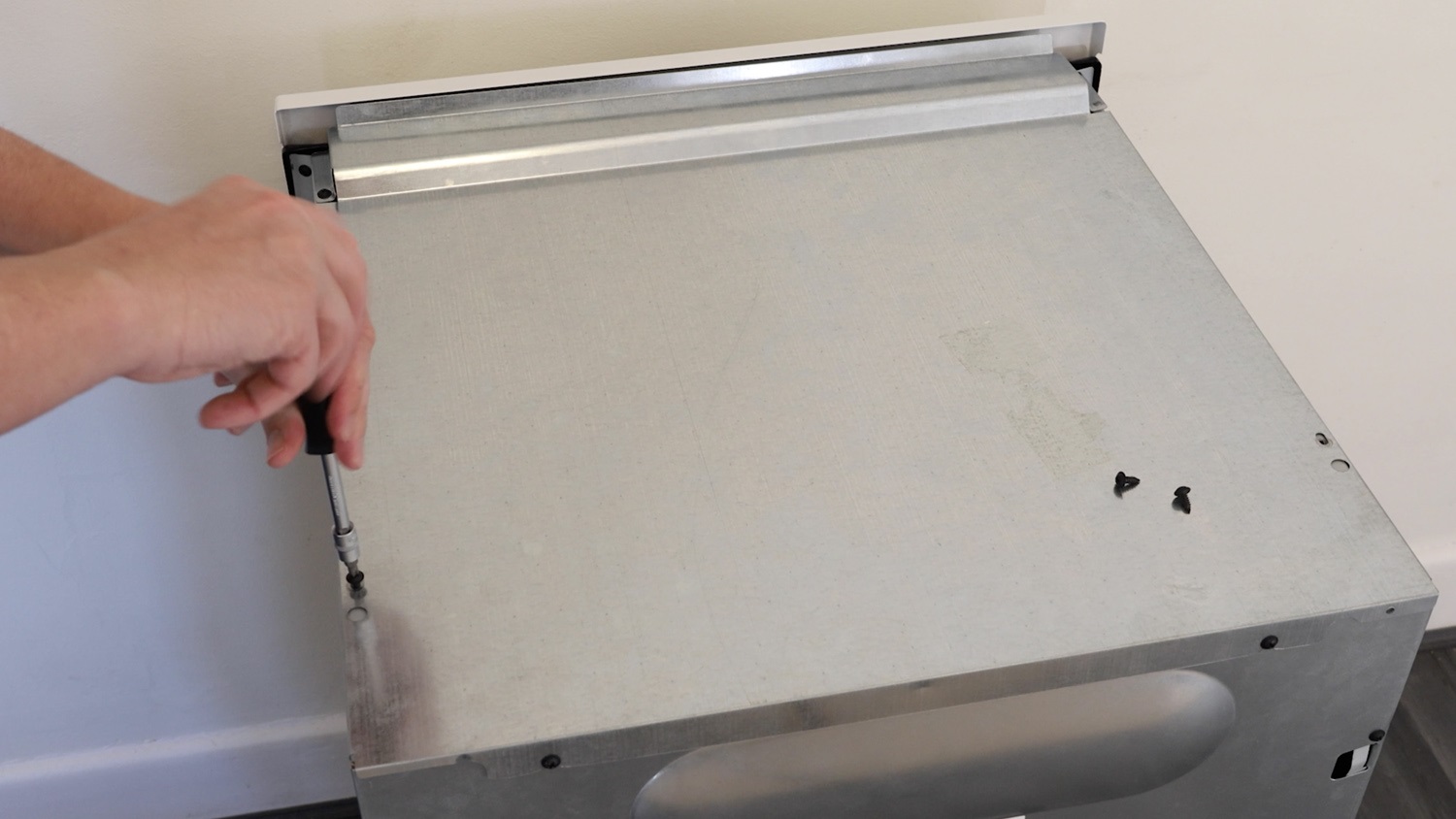 Remove oven top panel screws
