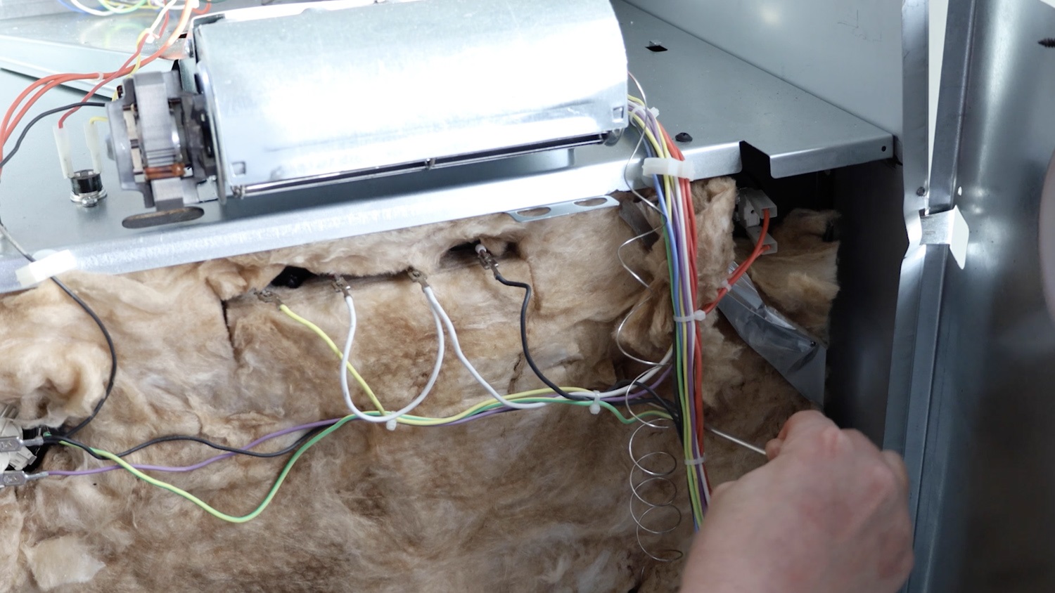 Feed new thermostat capillary tube through back of the top oven