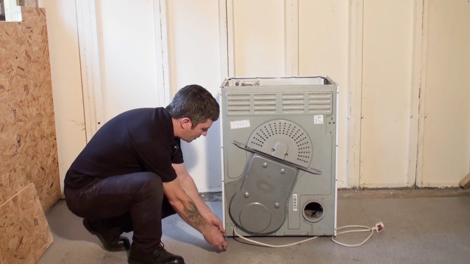 Remove screws at the rear of machine