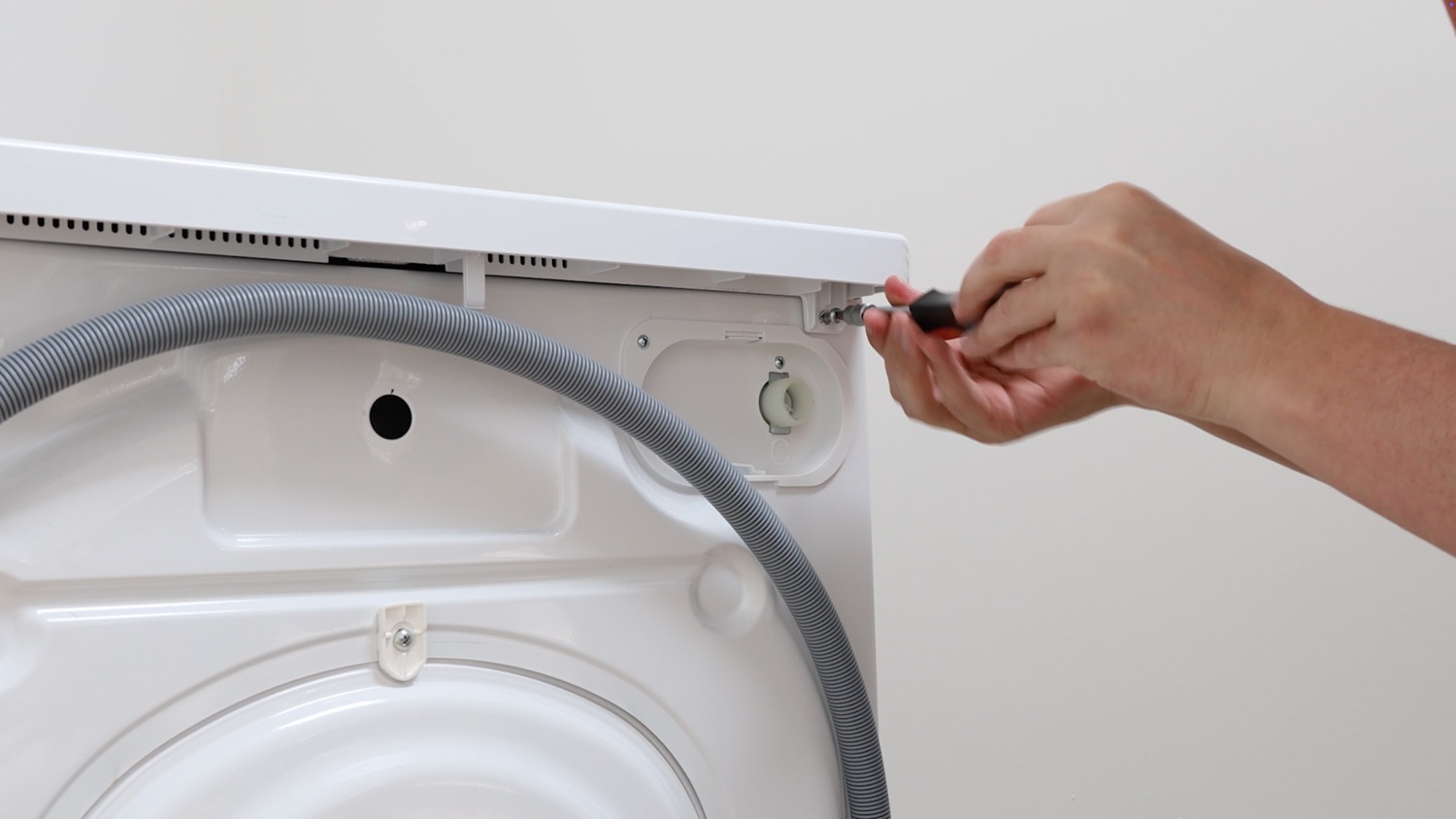Re-screw screws on rear of washing machine
