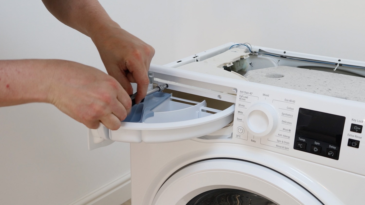 Remove two screws holding control panel to dispenser