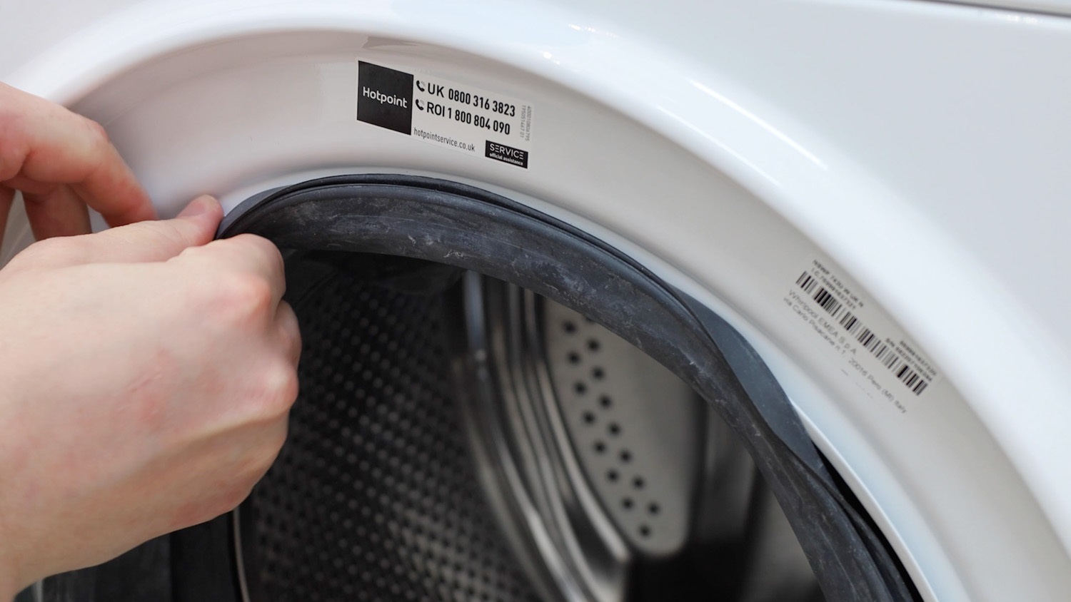 Feed door seal gasket over front lip of washing machine