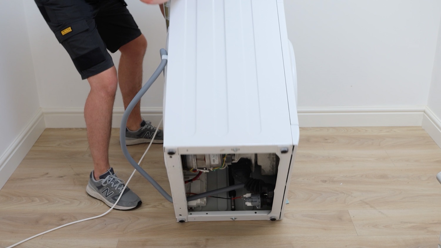 Gently lay washing machine on floor