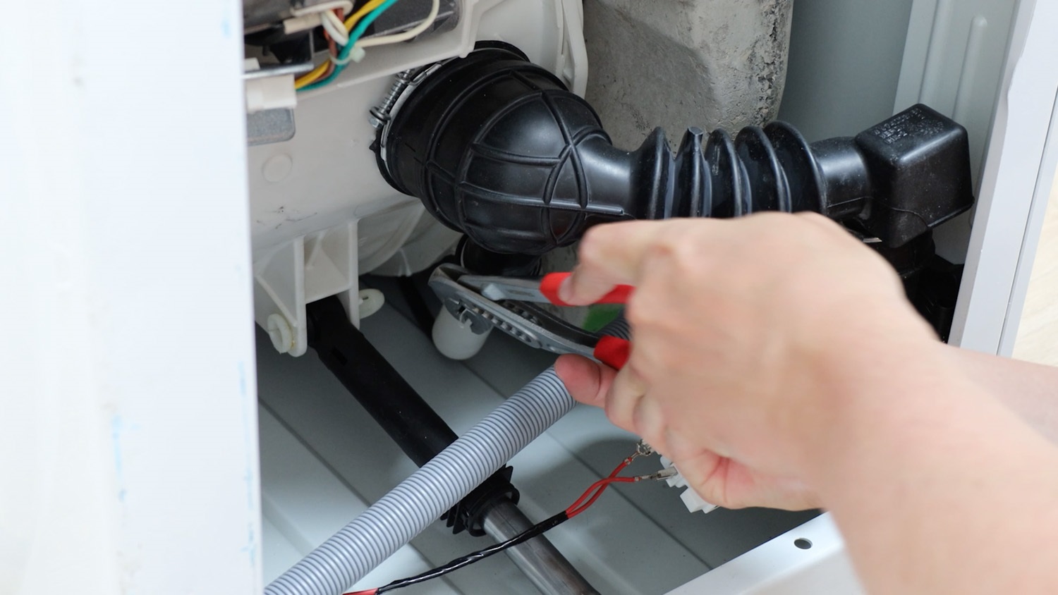 Squeeze wire hose clamp together and move down in place