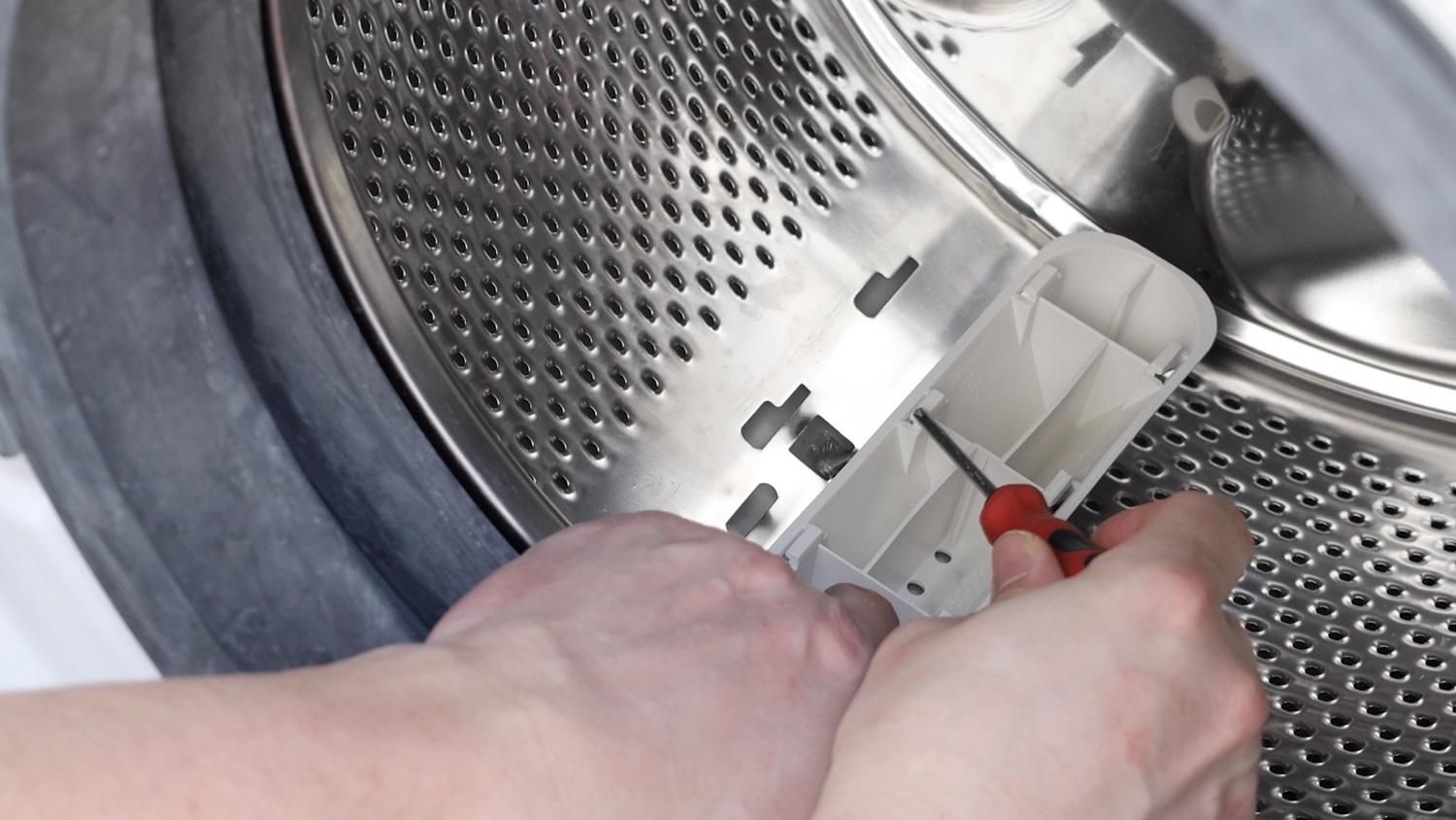The clips on the underside of thew new paddle slot into the openings on the washing machine drum