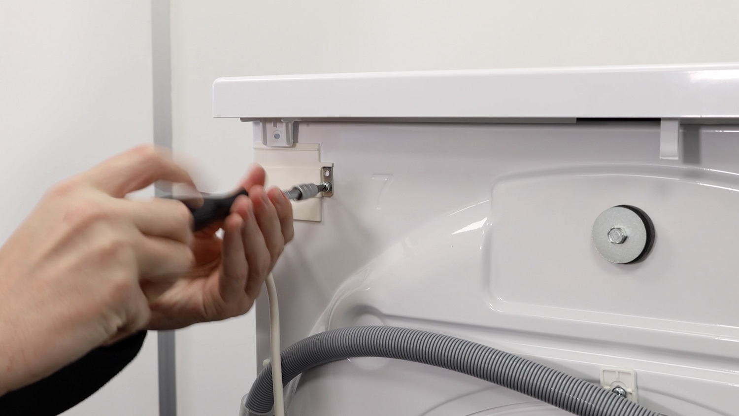 Re-screw screw holding the mains cable power lead in place
