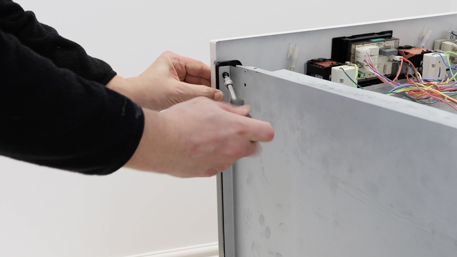 Re-screw screw holding side panel to front control panel