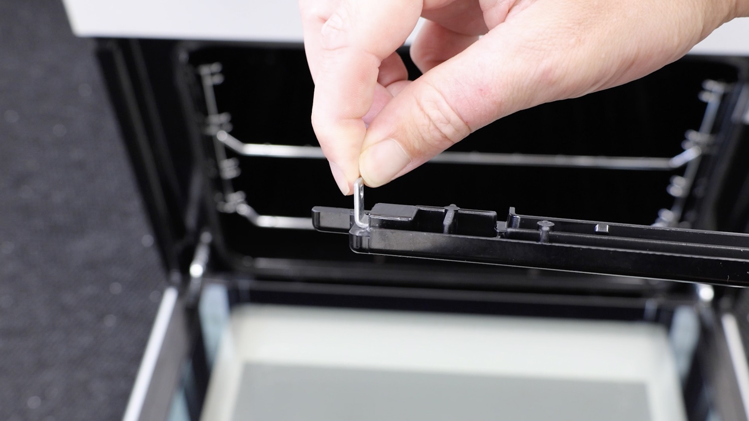 Re-attach fixing bracket to trim