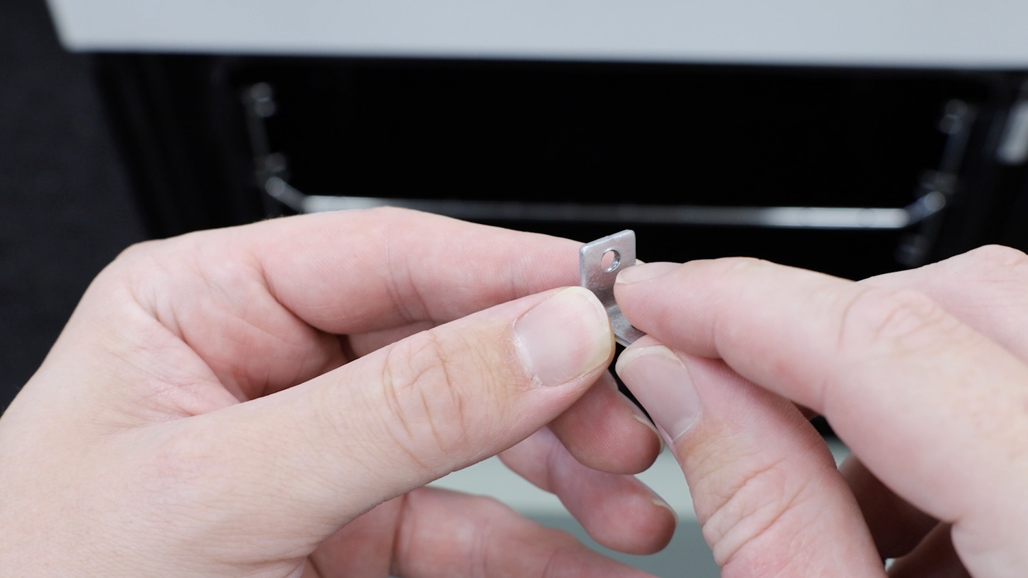 Re-insert top trim fixing bracket