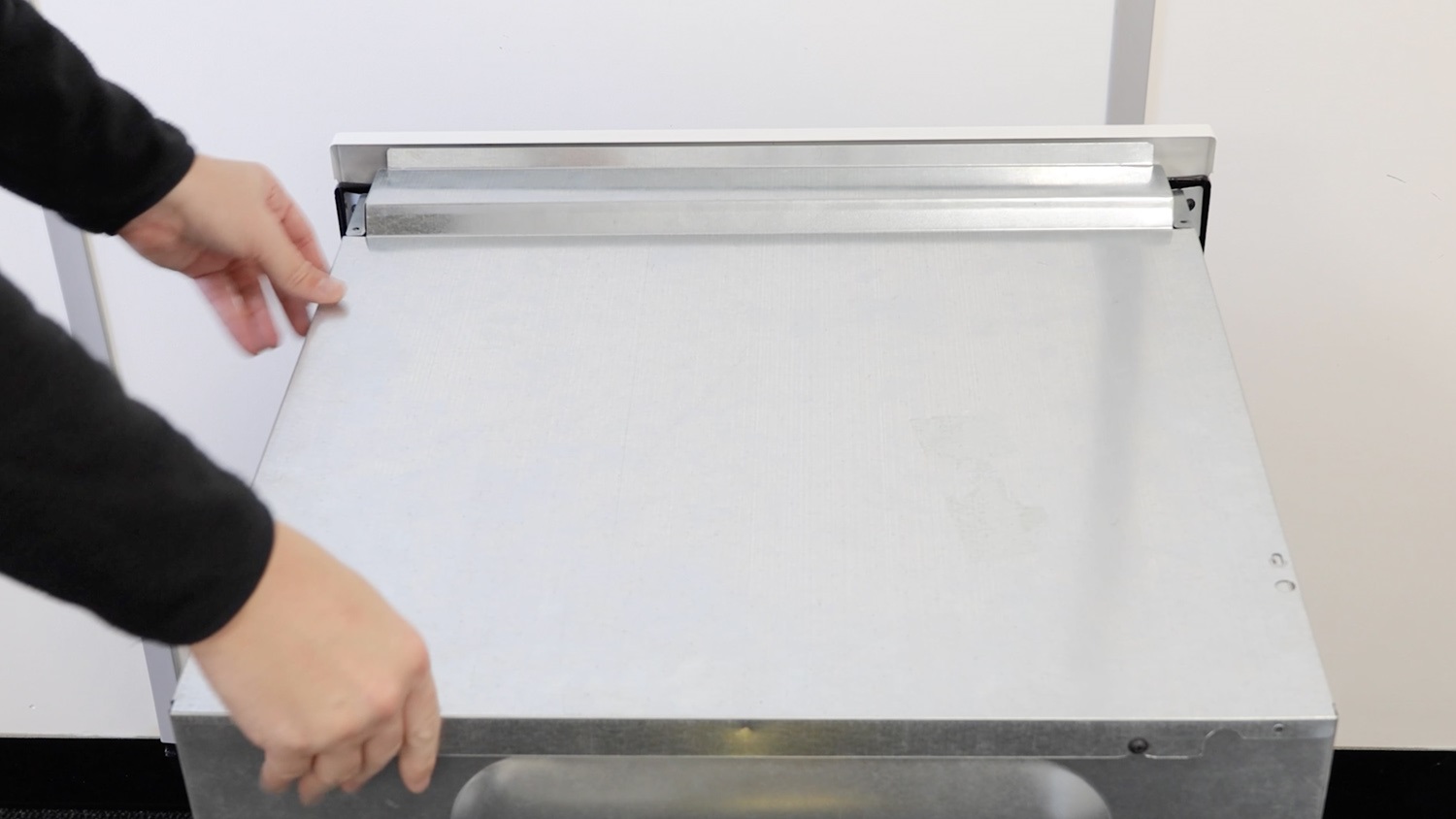 Place top panel back on oven