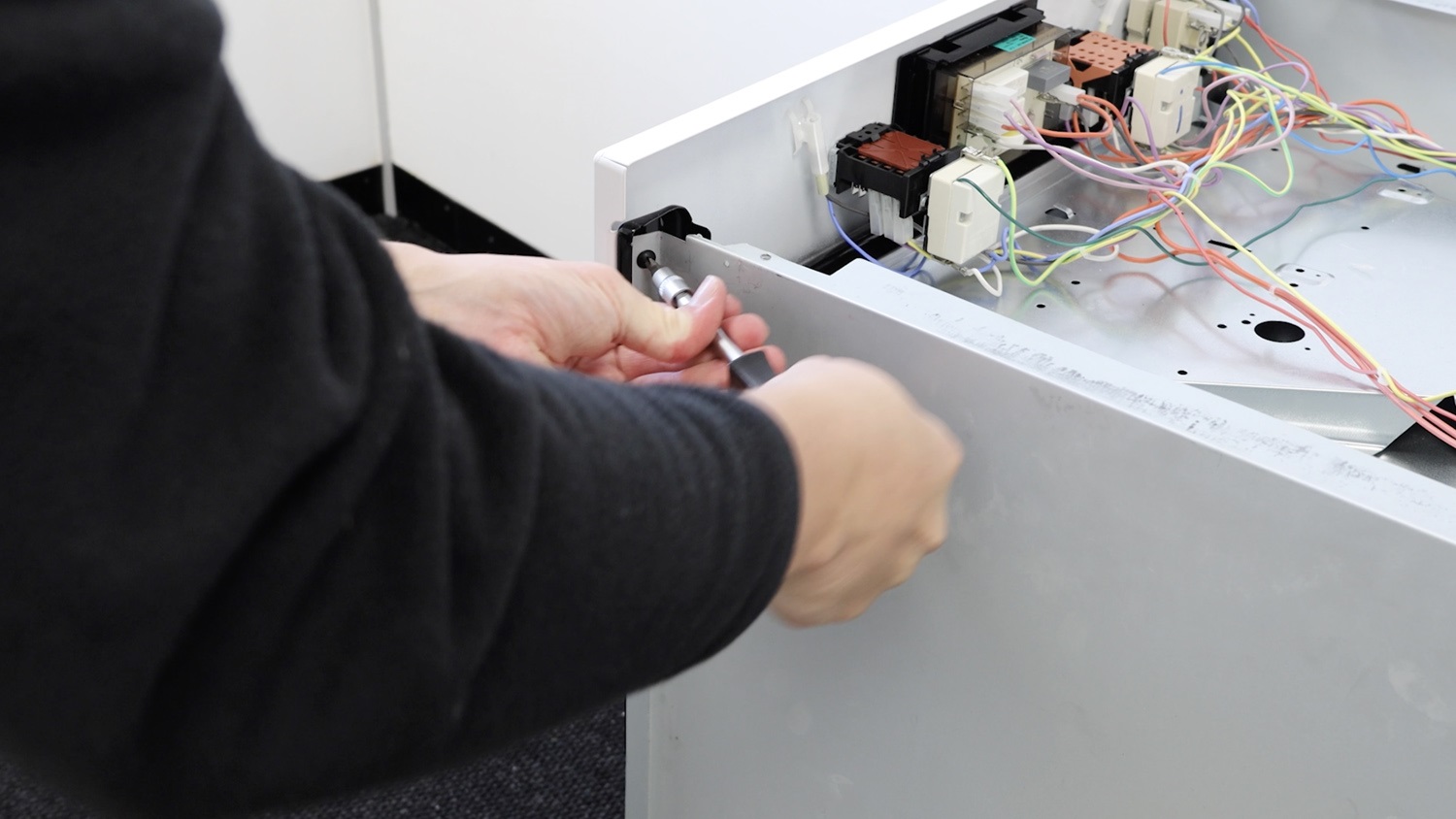 Re-screw side panel to front control panel
