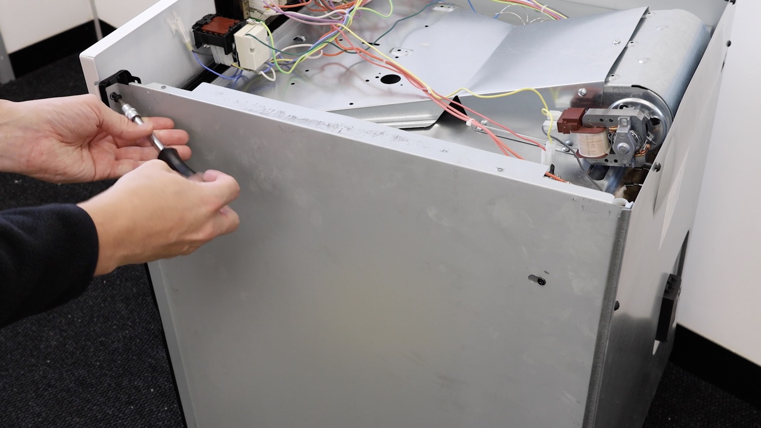 Remove screw from side panel and control panel