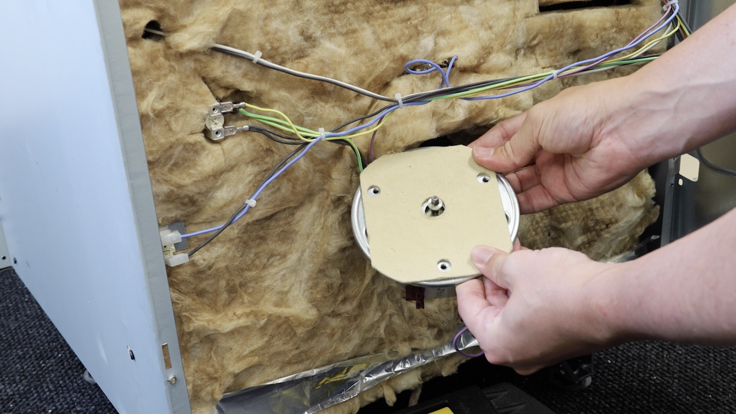 Attach new insulation plate to oven fan motor