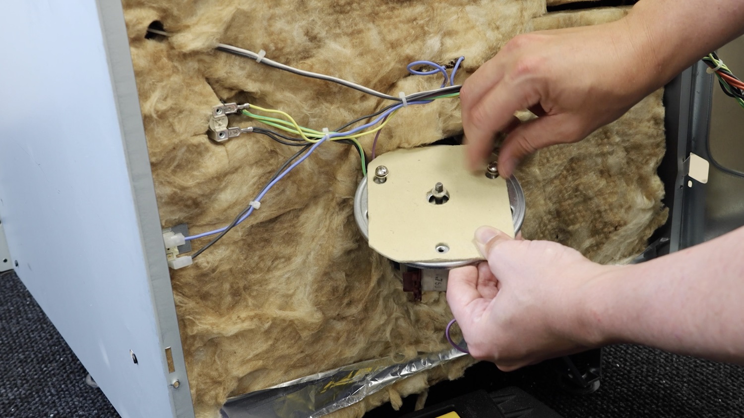 Slightly re-attach the top two screws