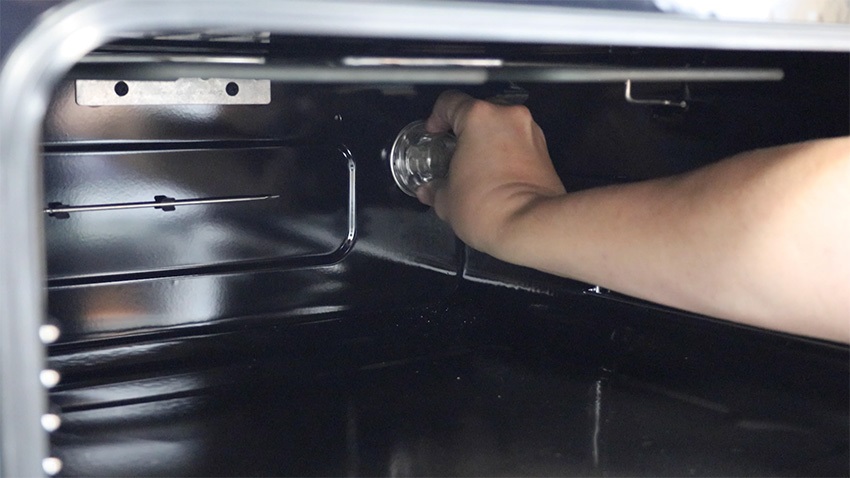 Unscrew the bulb cover and bulb from your oven