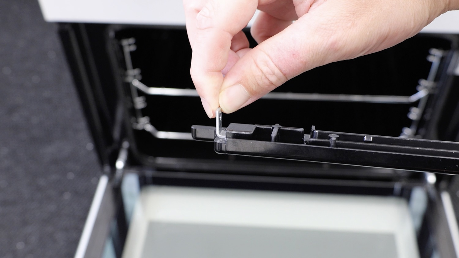 Place fixing bracket into the top trim