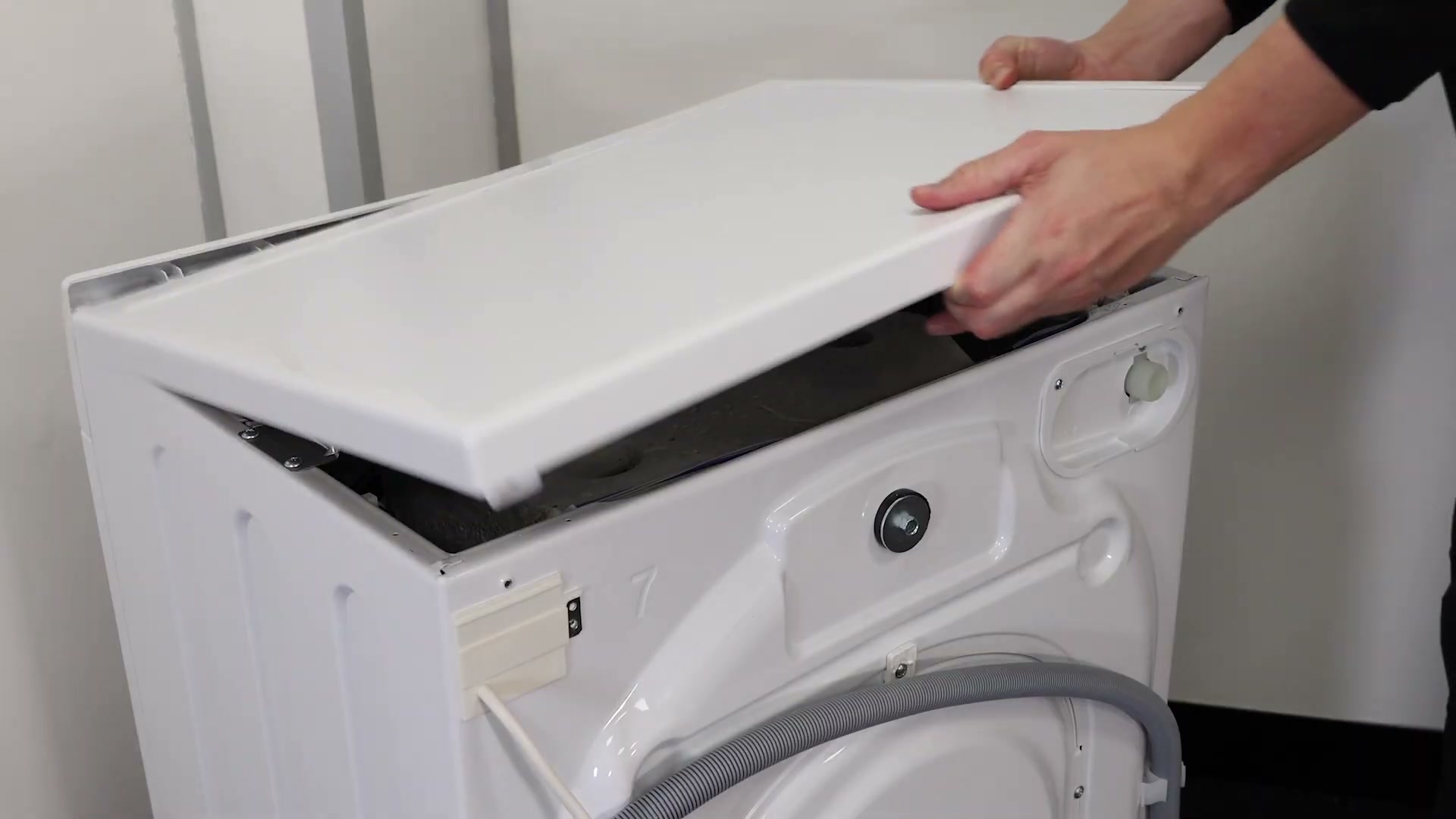 Hotpoint washing machine top lid being lowered back into place