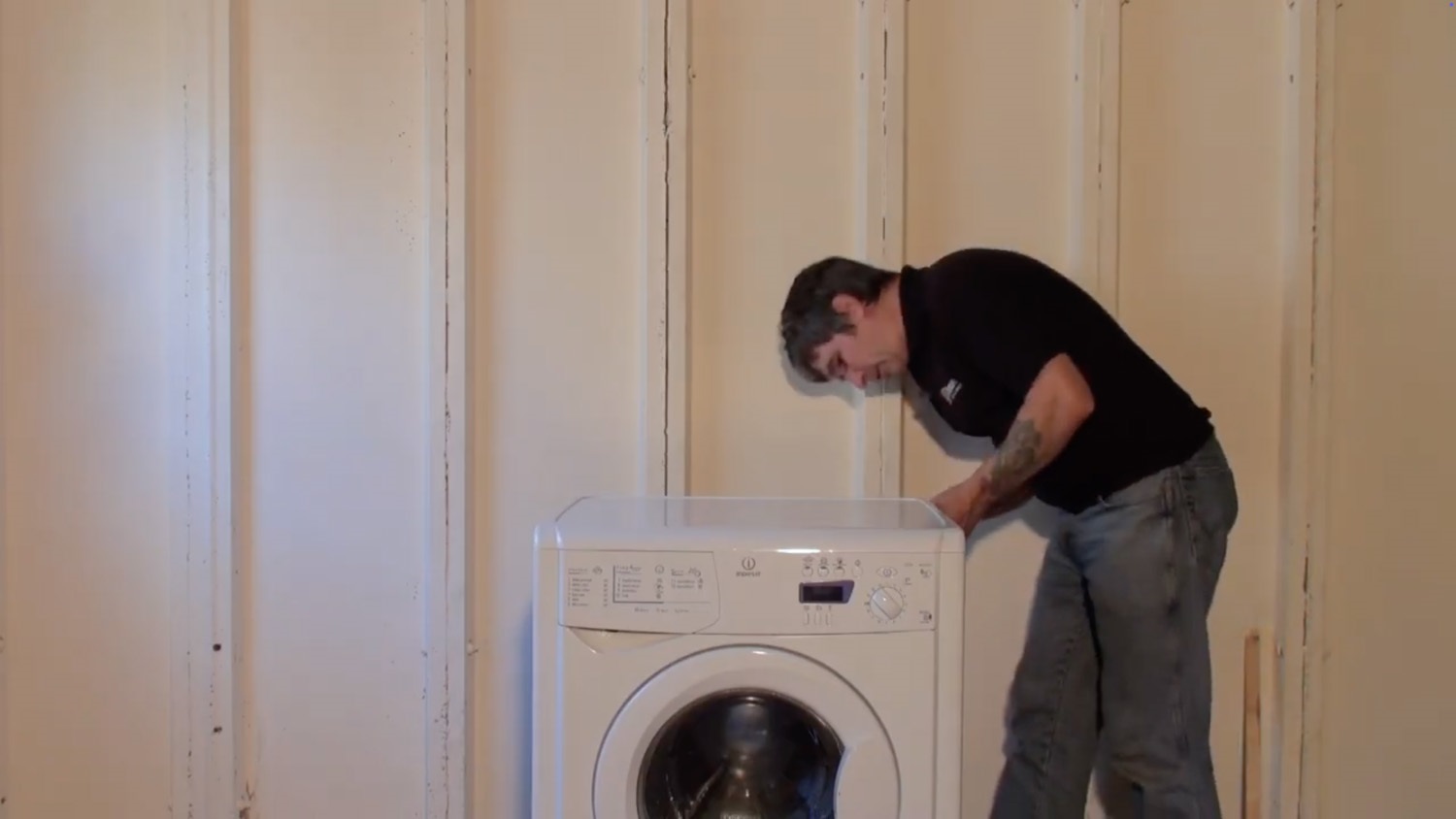 Remove screws on rear of washing machine for lid