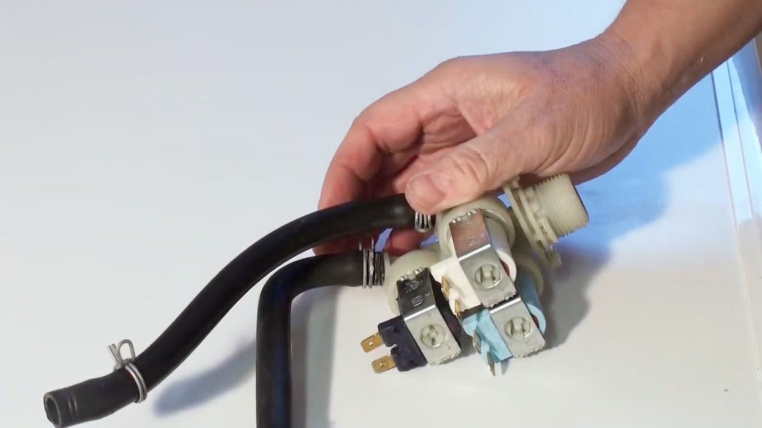 Attach hoses to new valve and clamp down the metal hose clamps