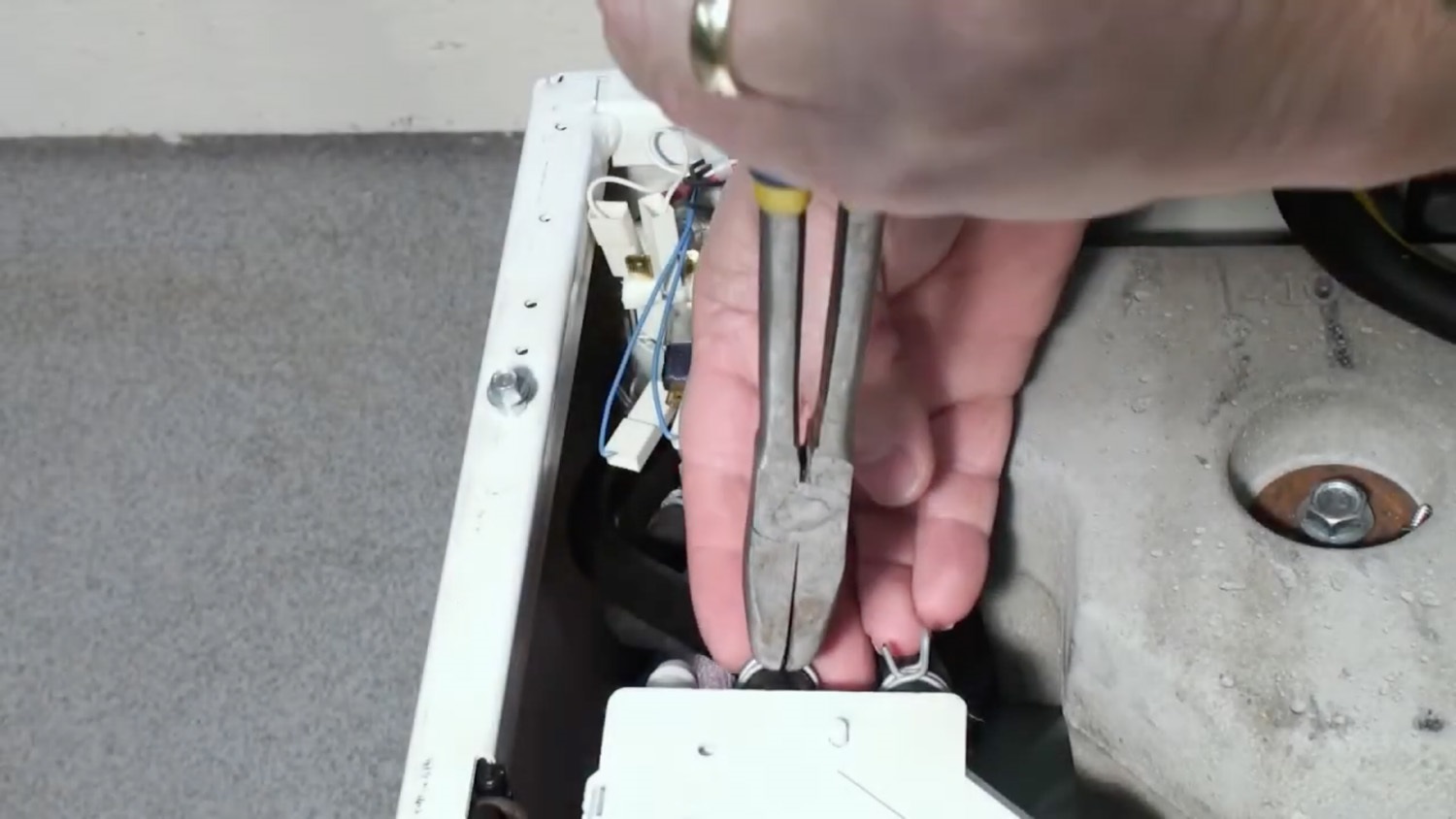 Pinch metal clamps to re-attach the hoses to dispenser